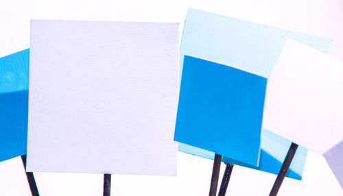 Close-up of paper hanging against white background