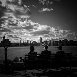 View of cityscape against cloudy sky