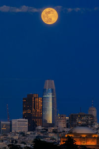 Buildings in city against sky at night