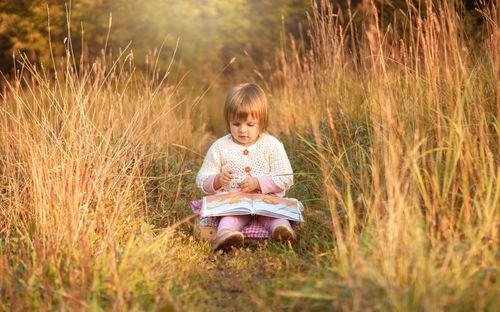 Girl sitting on book