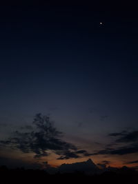 Scenic view of silhouette moon against sky at night