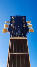 Low angle view of illuminated tower against clear blue sky