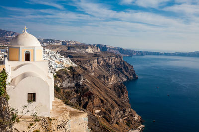 The aegean sea and the catholic church of st. stylianos in the city of fira in santorini island