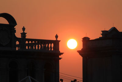 Low angle view of silhouette building against sky during sunset