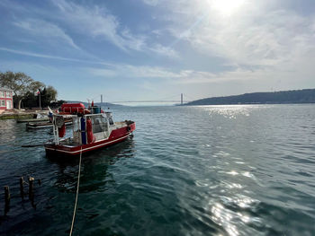 Boat moored in sea against sky