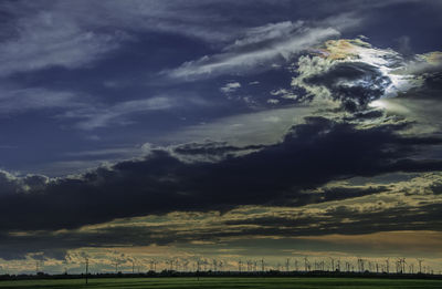 Scenic view of agricultural field against storm clouds