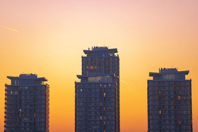 Low angle view of buildings against sky during sunset