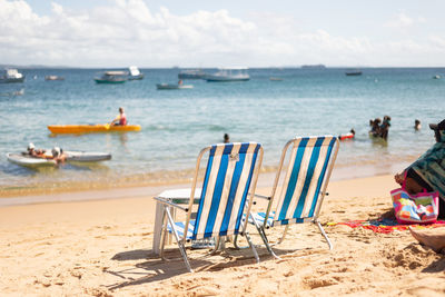 People have fun and swim in the sea at porto da barra beach in the city of salvador, bahia.