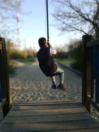 Boy on swing in playground