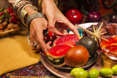 Midsection of woman holding strawberries