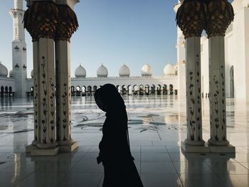 Side view of woman in mosque