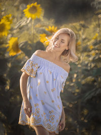 Beautiful woman standing at sunflower farm