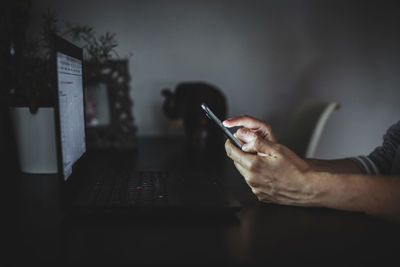 Midsection of man using mobile phone