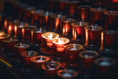 Close-up of lit tea light candles in row