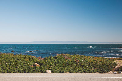 Scenic view of sea against clear blue sky