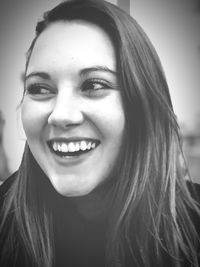 Close-up portrait of smiling young woman