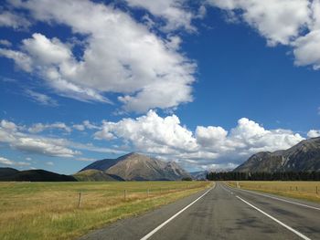 Empty road along countryside landscape
