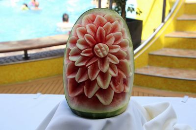 Close-up of rose in plate on table