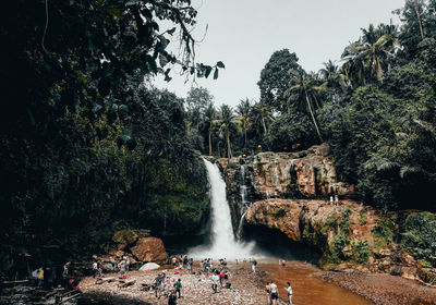 People against waterfall