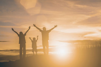 Silhouette people against clear sky during sunset