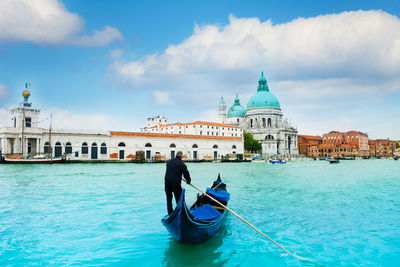 Rear view of people on boat in canal