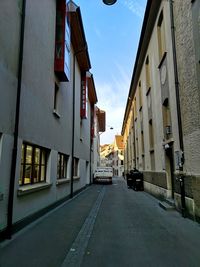 Street amidst buildings in city against sky