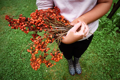 Midsection of woman holding fruits