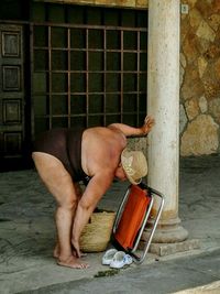 Woman looking through window