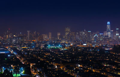 Illuminated cityscape against sky at night