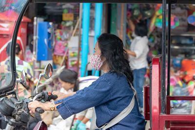 Woman standing at market stall