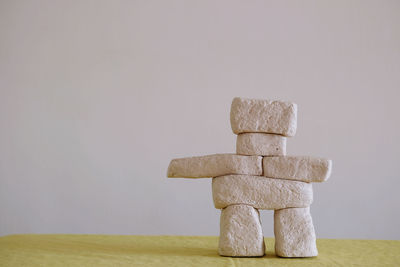 Stack of stones on table against white background