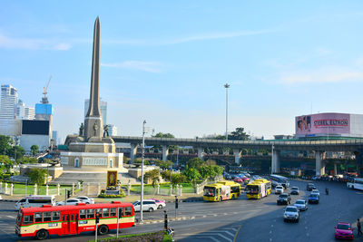 Traffic on road in city against sky