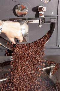 Ready-roasted coffee beans are transported to cool from the roasting machine