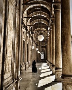 Rear view of woman walking in mosque