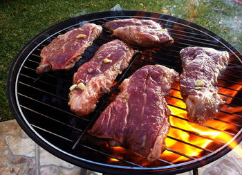 High angle view of meat on barbecue grill