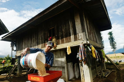 Low angle view of people working on building