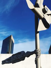 Low angle view of sculpture against building