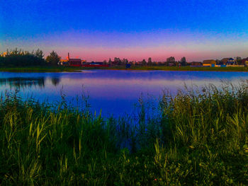 Scenic view of lake against sky during sunset