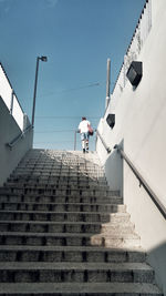 Low angle view of man walking up stairs