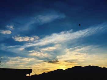 Low angle view of silhouette birds flying against sky