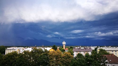 Buildings against cloudy sky