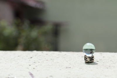 Close-up of toy car on table against wall