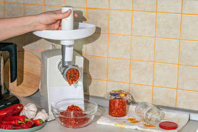 Cropped hand of person preparing food on table