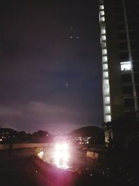 Illuminated building against sky at night