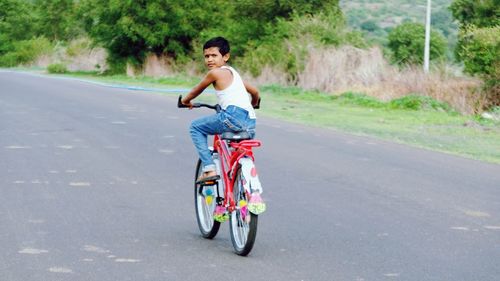 Man riding bicycle on road