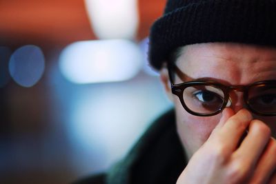 Close-up portrait of young man wearing eyeglasses