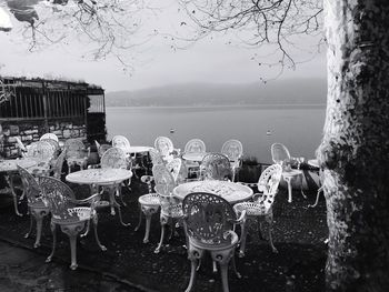 Panoramic shot of table and trees by lake against sky