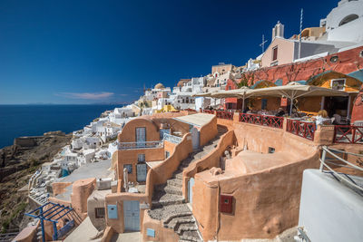 Buildings in city against blue sky