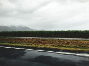 Scenic view of landscape against cloudy sky