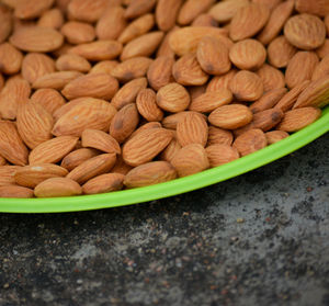 Almonds on a plate. almonds are healthiest nuts and one of the best brain foods.